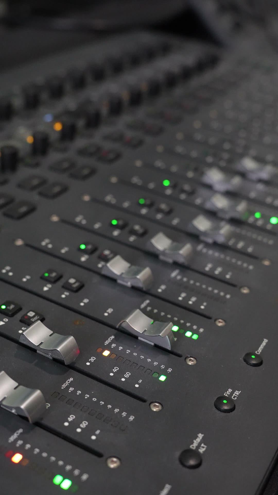 Close-up of the studio's fader control surface during a mix