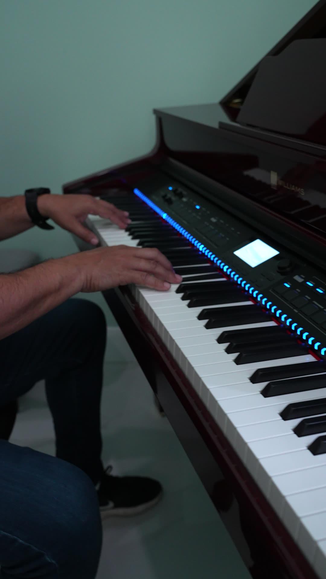 Hands playing the Williams digital grand piano